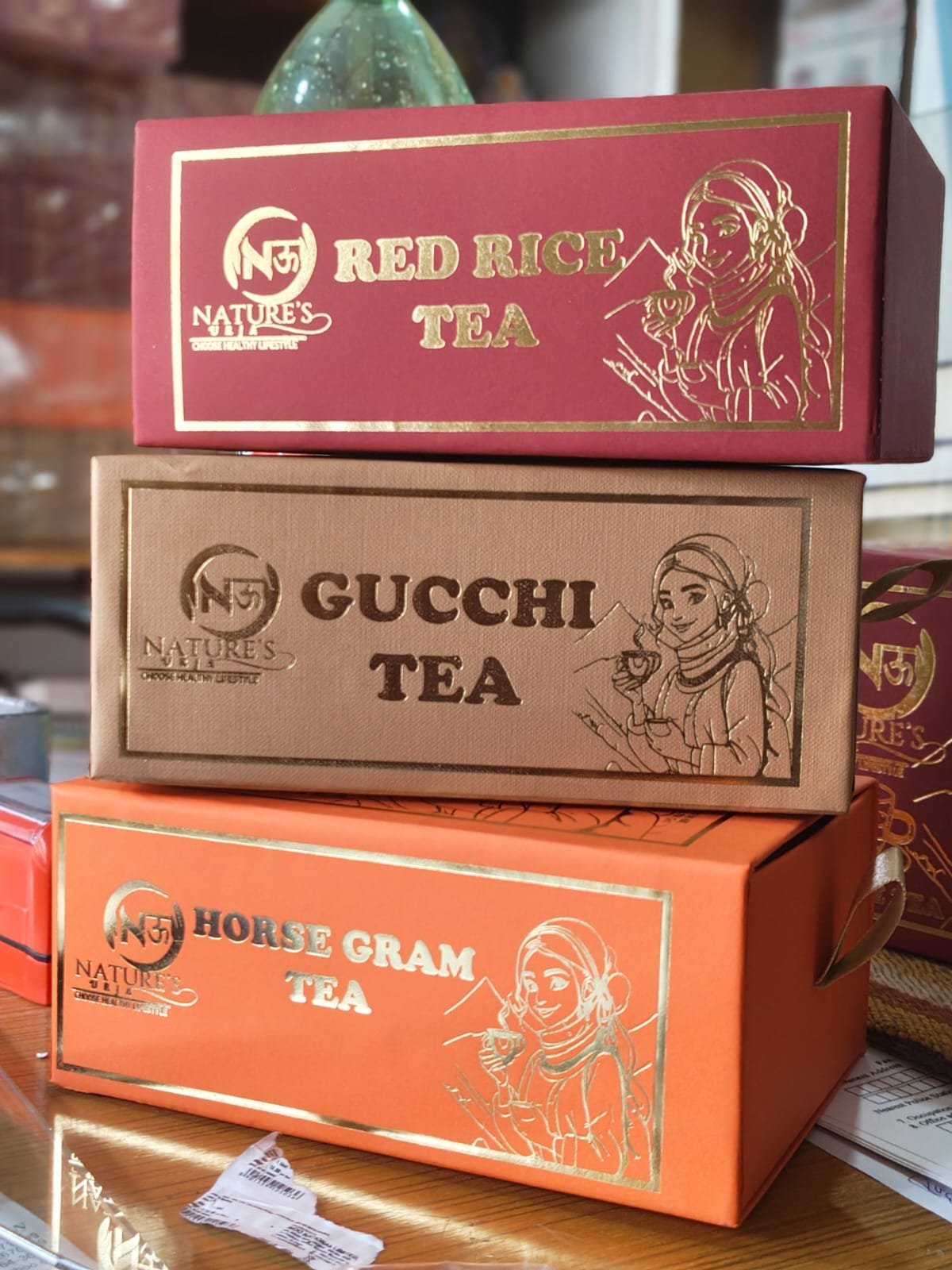 Nature’s Urja tea collection in burgundy, tan and terracotta gift boxes